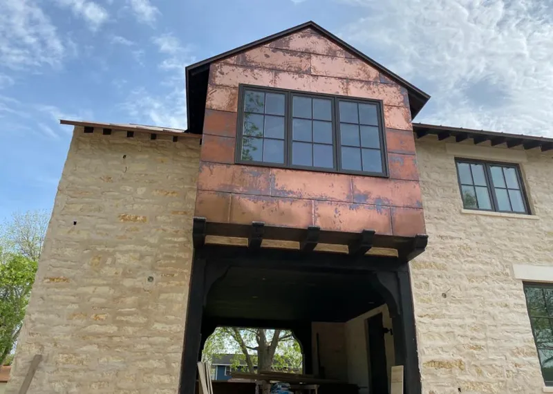 Copper metal panel facade on a stone building for Metal Roof Coating in Osage Beach